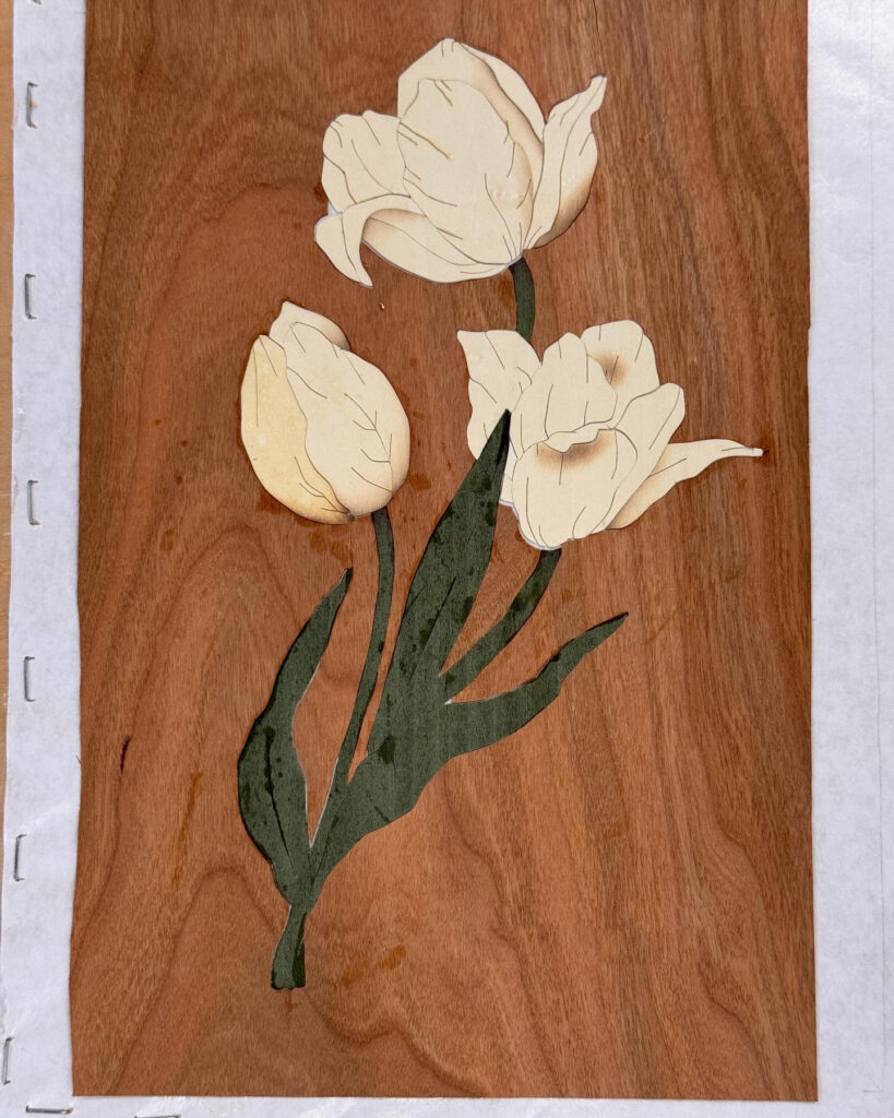 Marquetry picture of a sand shaded white tulip