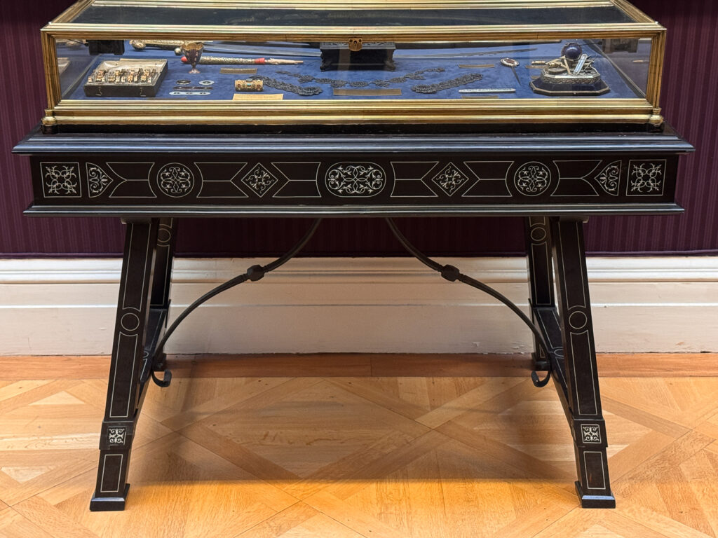 A 19th century display case from the Wallace Collection featuring elaborate ivory inlaid into ebony.