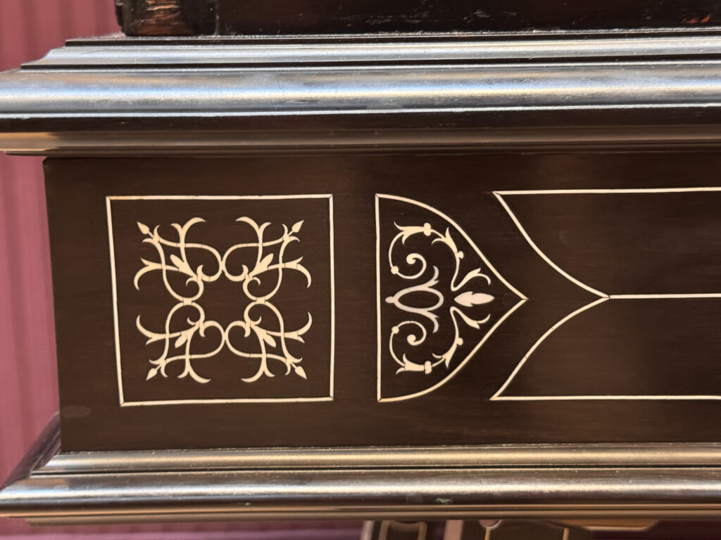 Detail of a 19th century display case from the Wallace Collection featuring elaborate ivory inlaid into ebony.