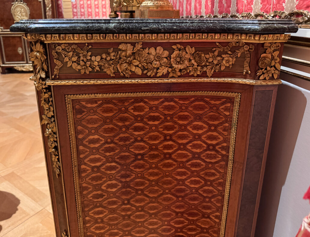 Detail of a side brass floral swag on a late 18th century cabinet by Reisner