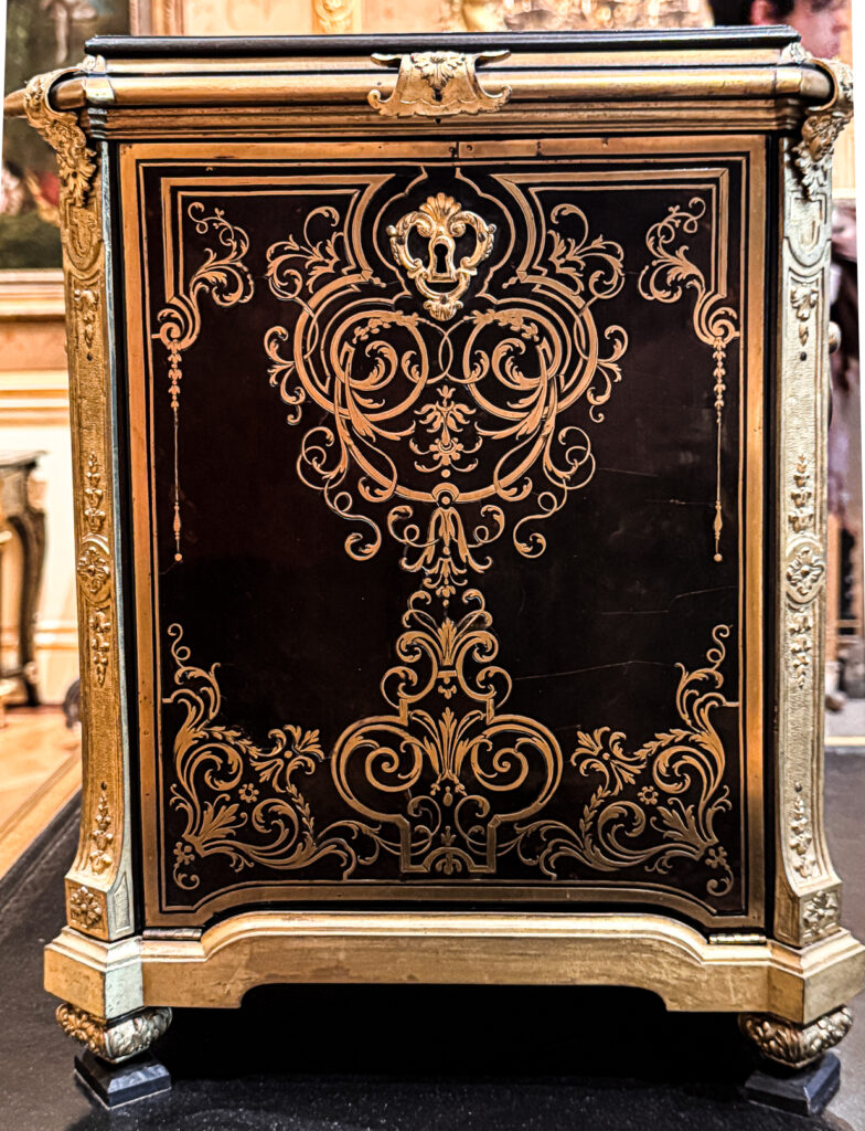 A clock case attributed to Charles Andre Boulle, 18th century French with heavy ormolu detail and brass and ebony marquetry