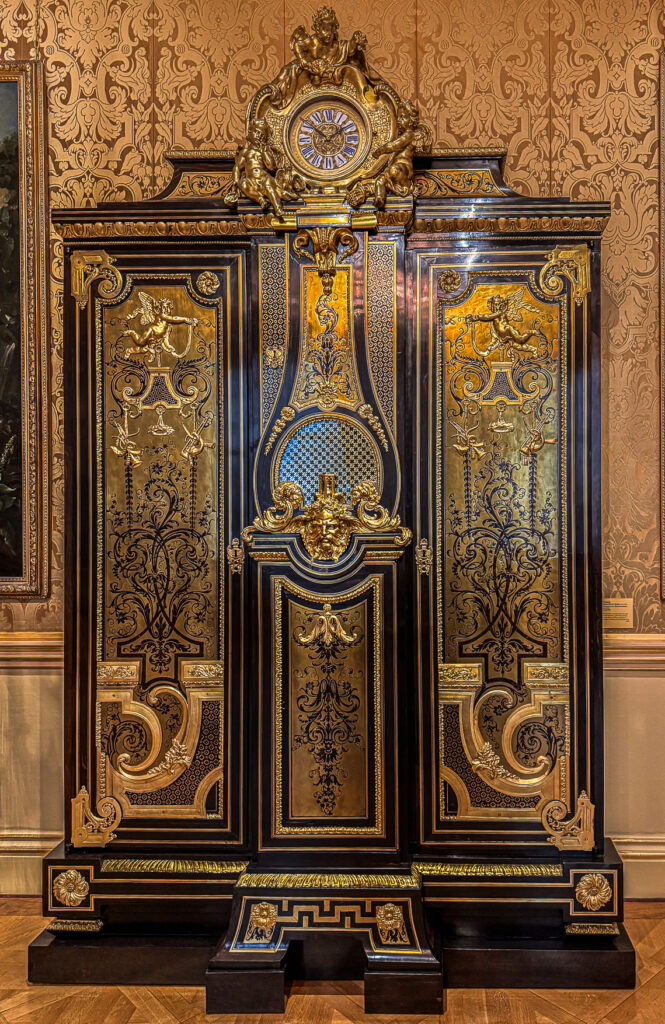 Large cabinet with a clock attributed to Charles Andre Boulle, 18th century French with heavy ormolu detail and brass and ebony marquetry