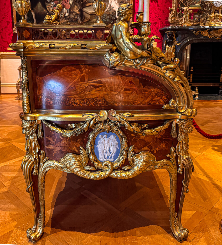 A desk attributed to Charles Andre Boulle in the Louis XV style with heavy ormolu detail and brass and walnut marquetry