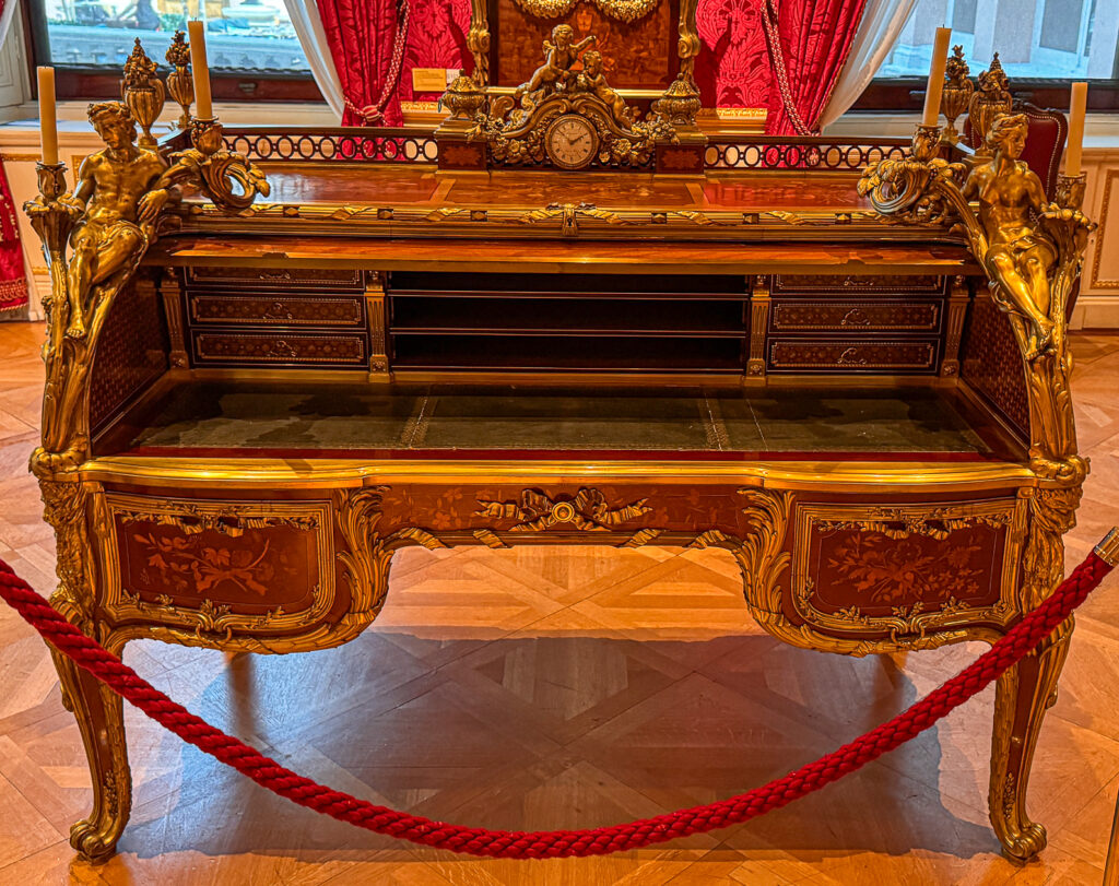 A desk attributed to Charles Andre Boulle in the Louis XV style with heavy ormolu detail and brass and walnut marquetry